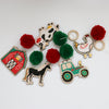 Set of farm-themed wooden garland pieces with colorful pom-poms on a white background - garland kit by Woodsy Craft Co.