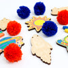 Kids Outer Space Garland Kit being colored - showing all the pieces included as well as pom poms and markers.